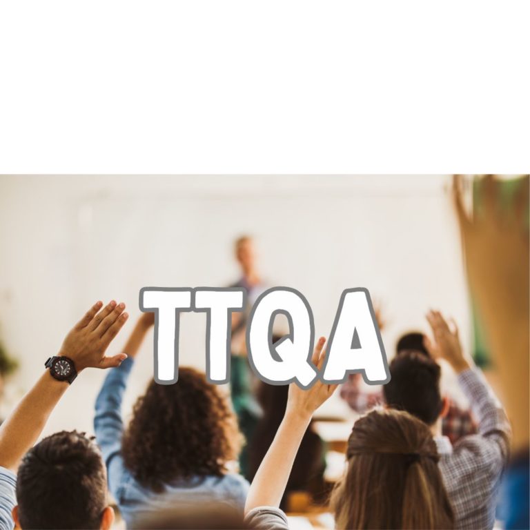 Students in a classroom raise their hands. Students are facing a teacher whose image is blurred in the background. The letters TTQA are seen over the image.